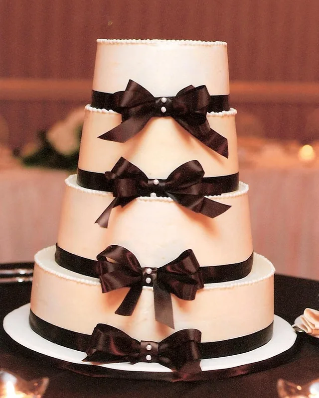 Four-tier cake wrapped in chocolate brown satin bows