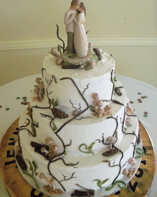 Woodland-themed wedding cake with piped branches and sugar mushrooms