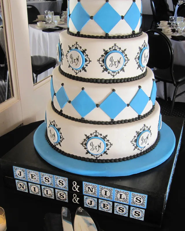 Diamond-patterned cake in teal and white with monogram medallions
