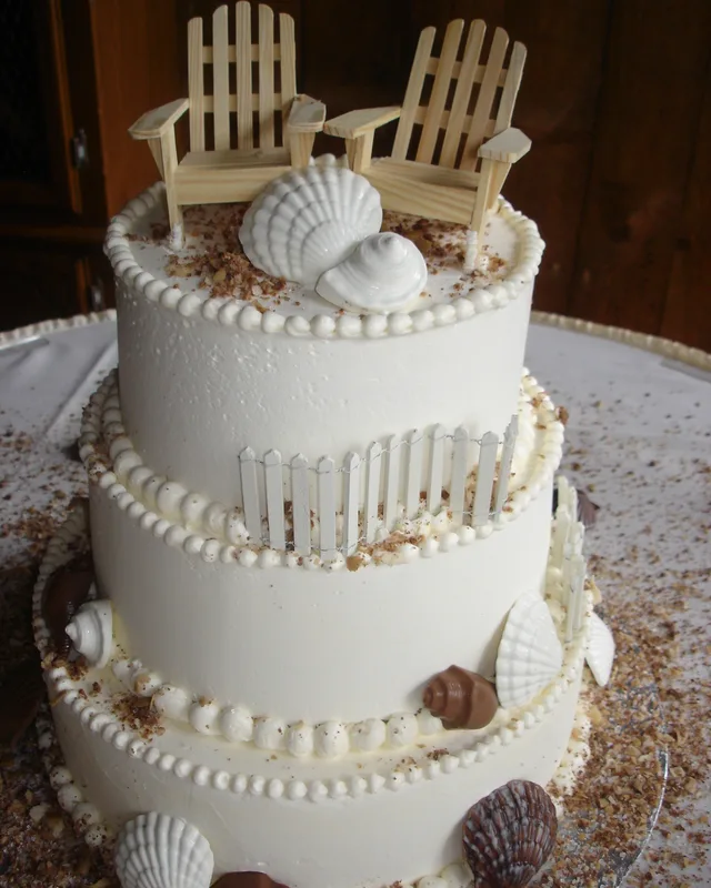 Beach-themed cake with Adirondack chairs and sugar seashells