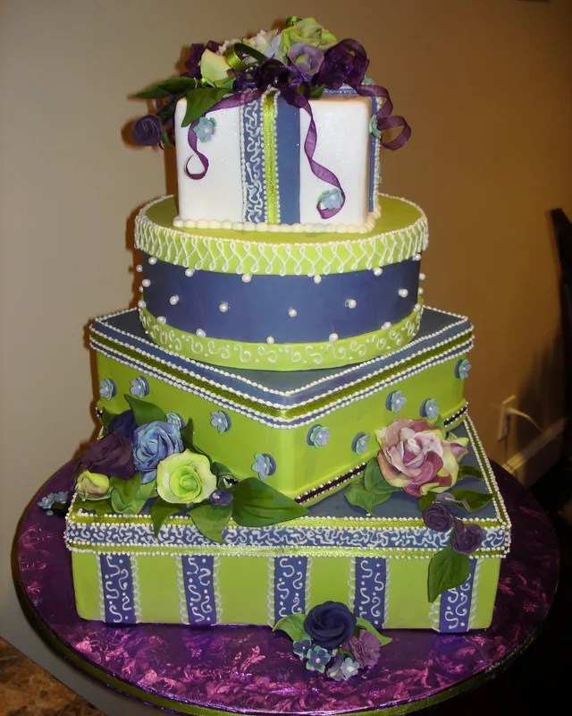 Stacked gift-box cakes in lime green, navy and purple