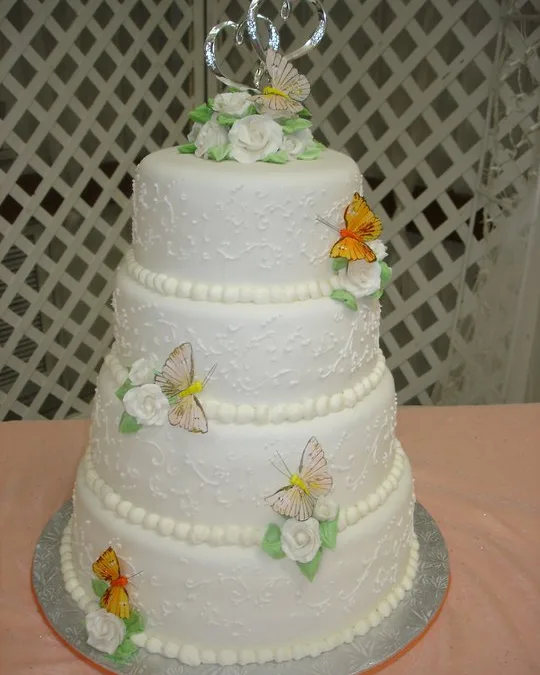 Three-tier cake with sugar butterflies and flowers