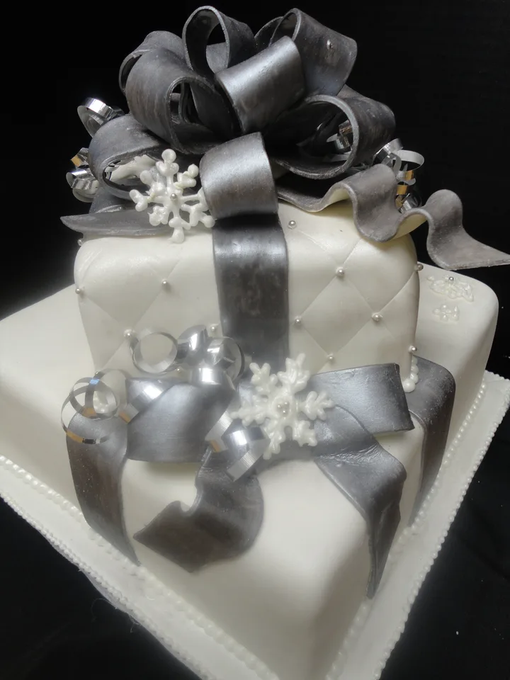 Sculpted gift-box cake with a large silver fondant bow
